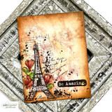 Warm orange grunge card of the Eiffel Tower stamped "Be Amazing."