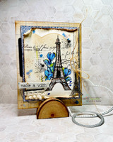 Golden vintage card of the Eiffel Tower with blue floral accents.