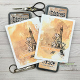 Distress-ink tag cards featuring the Eiffel Tower in aged tones.