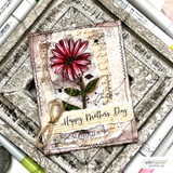 Card of a pink gerbera daisy over French script with "Happy Mother's Day."