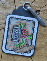Blue scalloped tag with the camera and a pink rose, finished with the forever-close sentiment and shown with a set of keys.