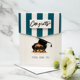 Card with a teal striped pocket and a peeking puppy in a graduation cap, "Congrats," "You did it!"