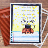 Navy card with a graduate peeking puppy on notebook paper, "You did it! Congrats"