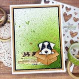 Card with a peeking puppy popping out of a kraft envelope on a green background