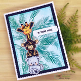 Darling Menagerie card, the sweet baby giraffe, bear and Highland calf grouped inside circle frames on a soft pastel background.