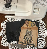 Black and kraft cat cards on a doily with balloons and the birdie birthday sentiment.