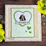 Card with a peeking spaniel puppy inside a green heart frame and "It's ruff without you"