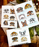 Several cards with peeking puppies of various breeds layered together
