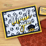 Card with a peeking puppy on a paw-print background and "thank you"