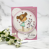 Garden girl in a green dress in a circle over doily layers with 'We love you so much.'