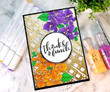Card with bougainvillea colored in purple and orange on a gold embossed lattice panel, matted in black with a white circle reading 'Thanks a bunch'.