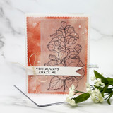 Card with the branch stamped in brown outline on a peach ink blended scalloped panel, a white banner reading 'You always amaze me' tied with twine.