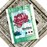 Card with the wood grain stamped in bright green behind a hand coloured red rose, matted on a pressed tin background with a thinking of you greeting.