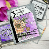 Purple and pink card with the wood planking stamped over blended distress inks, a large hand coloured peony and a small prayers banner, photographed with oxide ink pads.