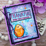 Bright blue and purple mixed media card with the tile pattern showing through, a hand colored orange bird and a thankful for fat pants label.