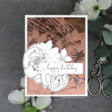 A copper and grey card with the cracked glass texture stamped in metallic ink behind an outlined white rose, on a dark background.