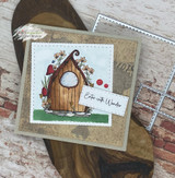 Card with a wooden fairy door surrounded by flowers and the sentiment 'Enter with Wonder.'