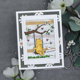 Card with Pooh on his swing in a die-cut frame with white flowers, 'Today we celebrate you.'