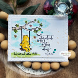 Watercolor card with Pooh swinging from a leafy branch, 'Don't underestimate the value of doing nothing.'