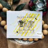 Yellow sun-rayed card of the friends on their bench with 'Cheers to being a golden girl' above.