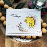 Card with coloured Winnie the Pooh reaching into a honey tree and 'Just checking in...thinking of you.'