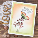 Warm card with a rainbow butterfly and stamped branches beside a gold 'love' die, 'A life so beautifully lived.'