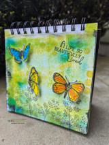 Mixed-media notebook with soft butterflies and 'A life so beautifully lived.'