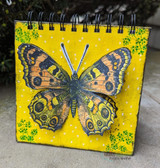 Yellow art-journal cover with a large detailed butterfly stamped in dark ink.