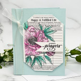 Soft teal card of the peony ledger background, 'sending prayers.'