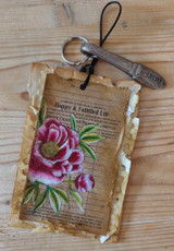 Kraft luggage tag with the peony ledger background and vintage keys.