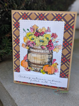 Barrel of fall blooms on a plaid-framed card, 'sending autumn's embrace, filled with love'.