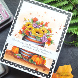 Barrel of vivid autumn flowers on a scalloped card, 'sending autumn's embrace'.
