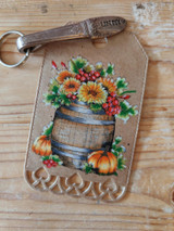 Sunflower barrel stamped on a kraft gift tag with pumpkins.