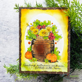 Barrel of fall flowers on a glowing golden card, autumn embrace sentiment.