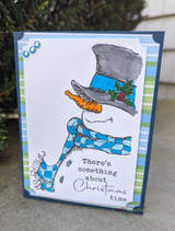 Card with the whimsical snowman in a top hat and plaid scarf on blue striped paper, holiday sentiment