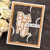 Starry moon background in warm brown behind a die-cut 'BEAUTIFUL' with 'you are so.'