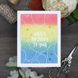 Sunset blended card in pink, yellow and blue with white balloon outlines and HAPPY BIRTHDAY TO YOU! in white lettering inside a circle.