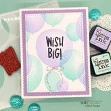 Mint card with a lavender frame and soft blended balloons, twine bow and WISH BIG! stamped in the largest balloon.