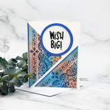Companion card with copper and blue paisley panels arranged diagonally and WISH BIG! in a navy stitched circle.
