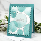 Teal card with soft blended balloons on a stamp edge panel, pearls and HOORAY embossed in white across the front.