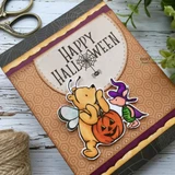 Kraft Halloween card featuring Pooh in a bee costume holding a jack-o'-lantern beside Piglet, under a bold 'Happy Halloween'.