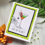 Card with an eyeball martini and cobweb on a green background and 'here for the boo's.'