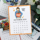 Angie Blom's Planner Gal cradles a pumpkin with 'happy fall,' a petite itty bitty red rubber stamp shown on an autumn card.