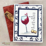 Card with a red-wine goblet and cork and 'it's not drinking alone if your dog is home' on a leopard border.