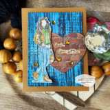 Rustic card with Ava Girl over a distressed blue woodgrain heart on a kraft panel.