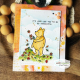 Warm autumn card of Pooh standing in a pile of colored leaves, sentiment 'It's just like you to be so thoughtful.'
