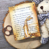 Vintage card with the rabbit on an aged 'The Velveteen Rabbit' book-page panel, tied with gingham.