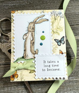 Clean card with the rabbit on a kraft panel with green ribbon, a butterfly and 'It takes a long time to become.'