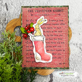 The rabbit tucked into a red stocking beside the Velveteen text on a festive card.