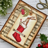 Vintage Christmas tag card with the rabbit in a red stocking on sheet-music paper, holly and the sentiment 'Merry Christmas'